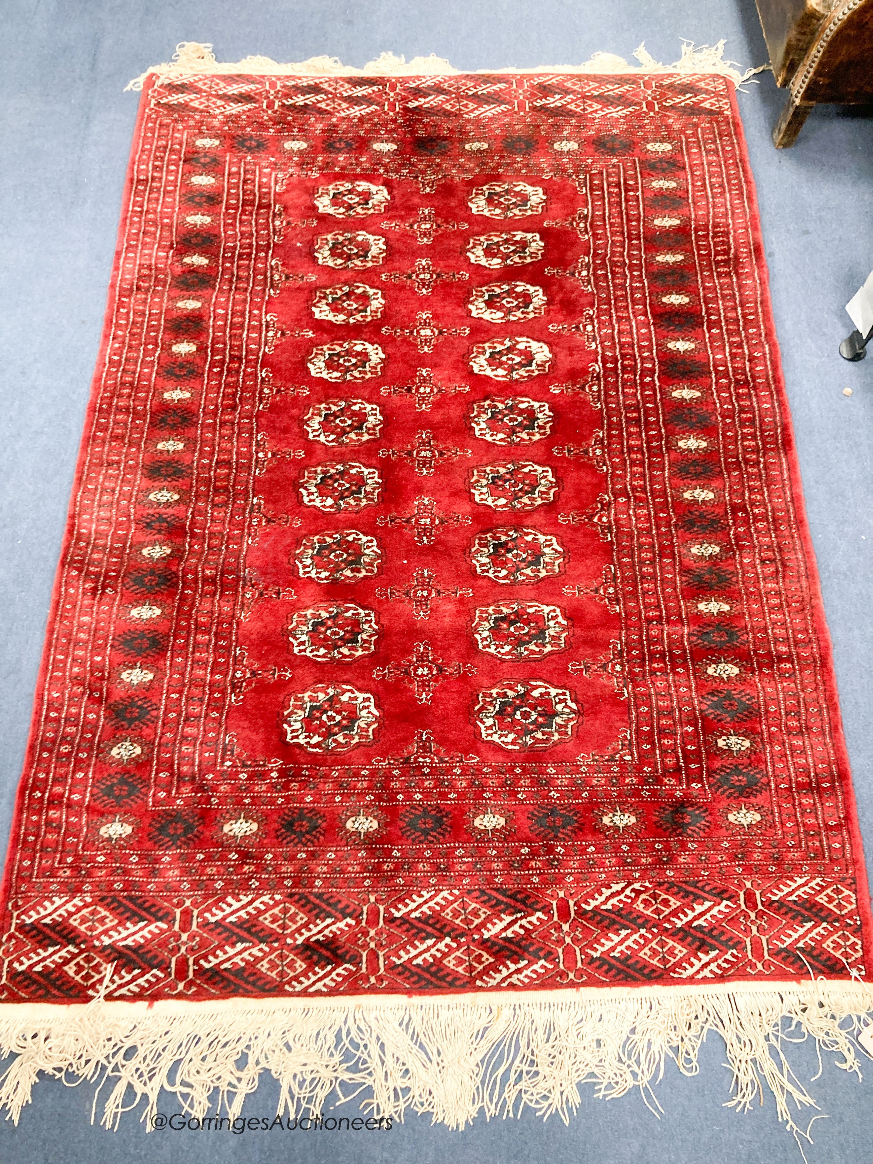 A Bokhara burgundy ground rug, 184 x 126cm